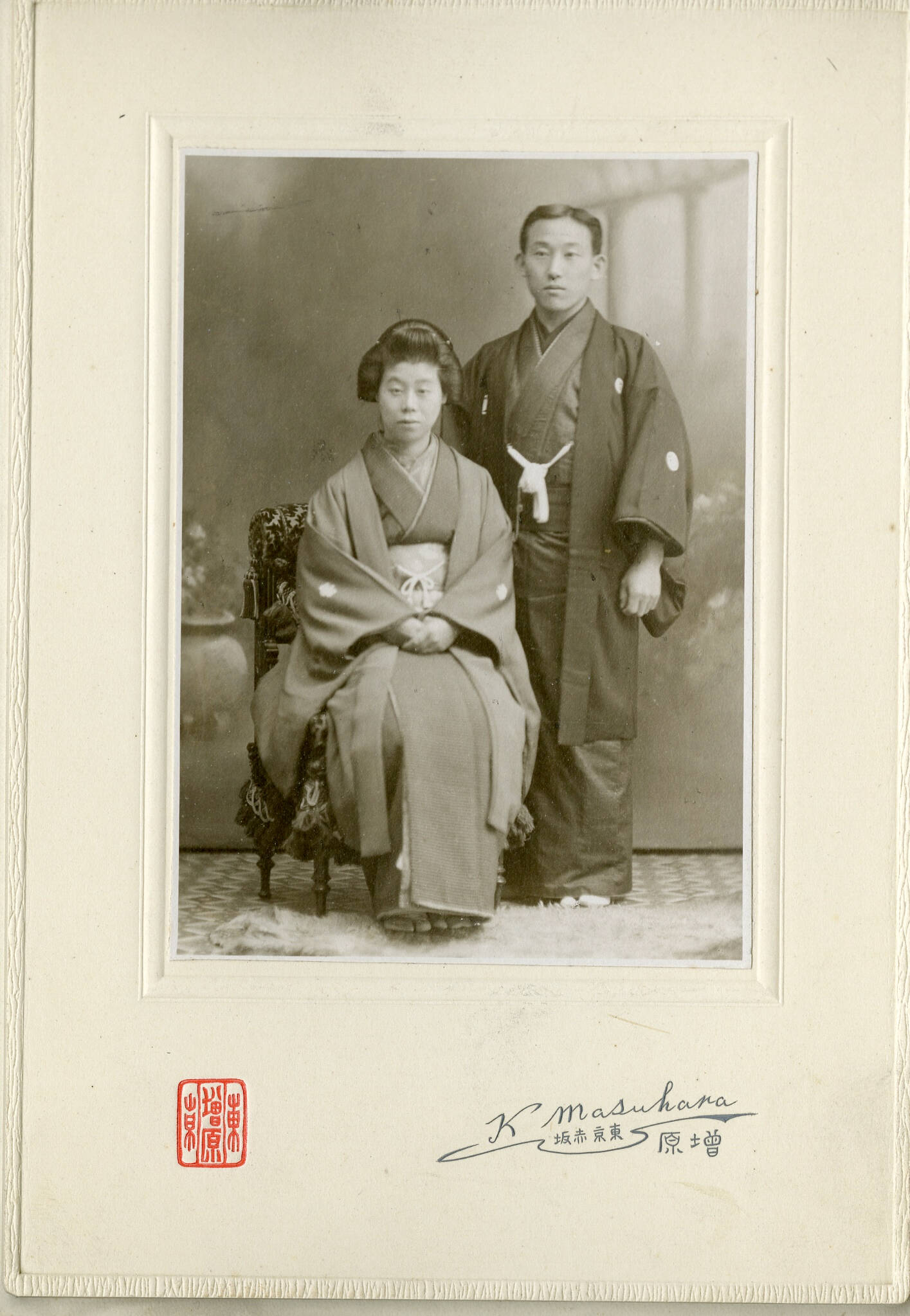 Historic black and white cabinet card photograph of a couple wearing traditional kimonos.